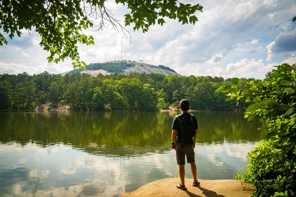 A man trekking on a lakeside in Georgia